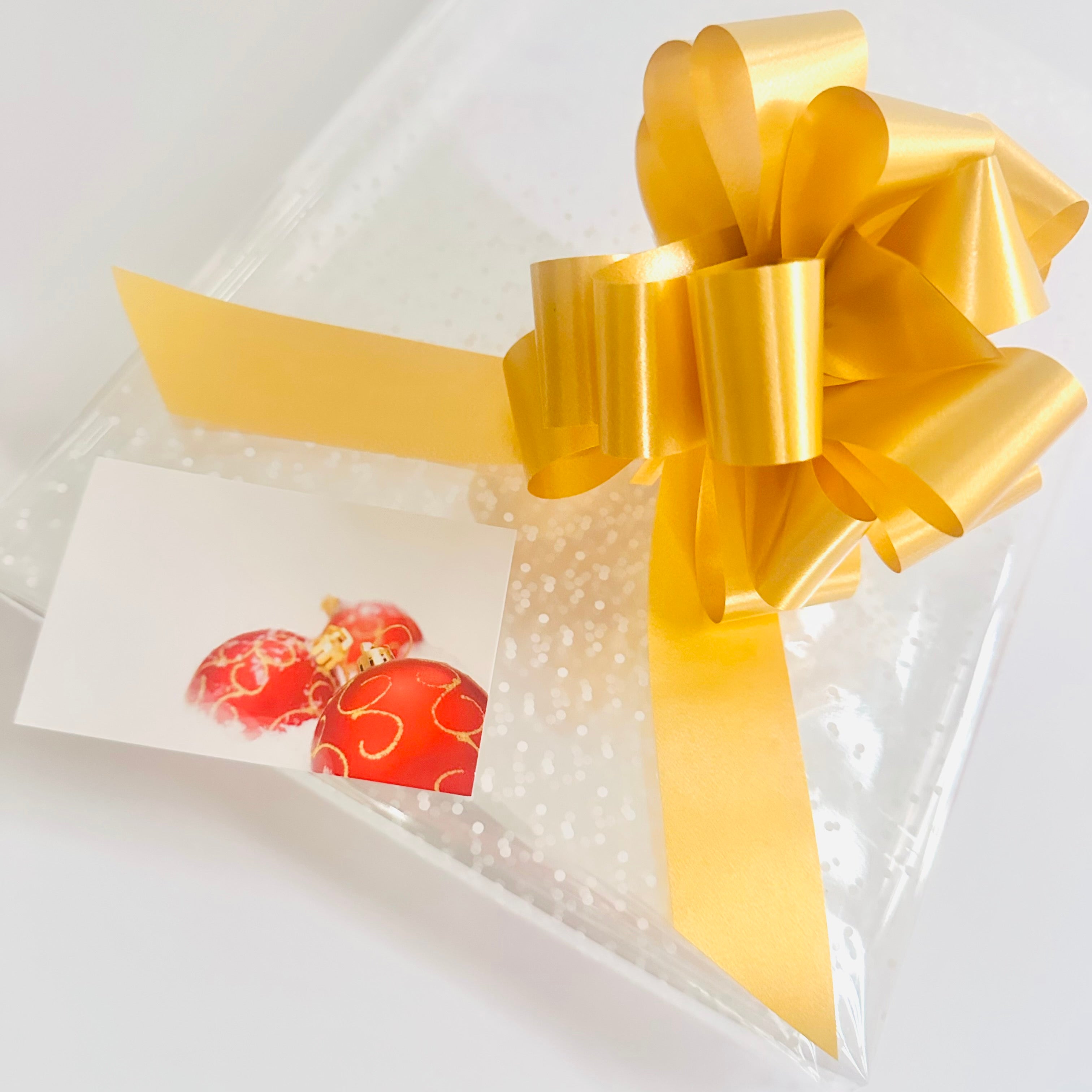 White dot Cellophane hamper wrap / Gold pull bow and Christmas bauble card