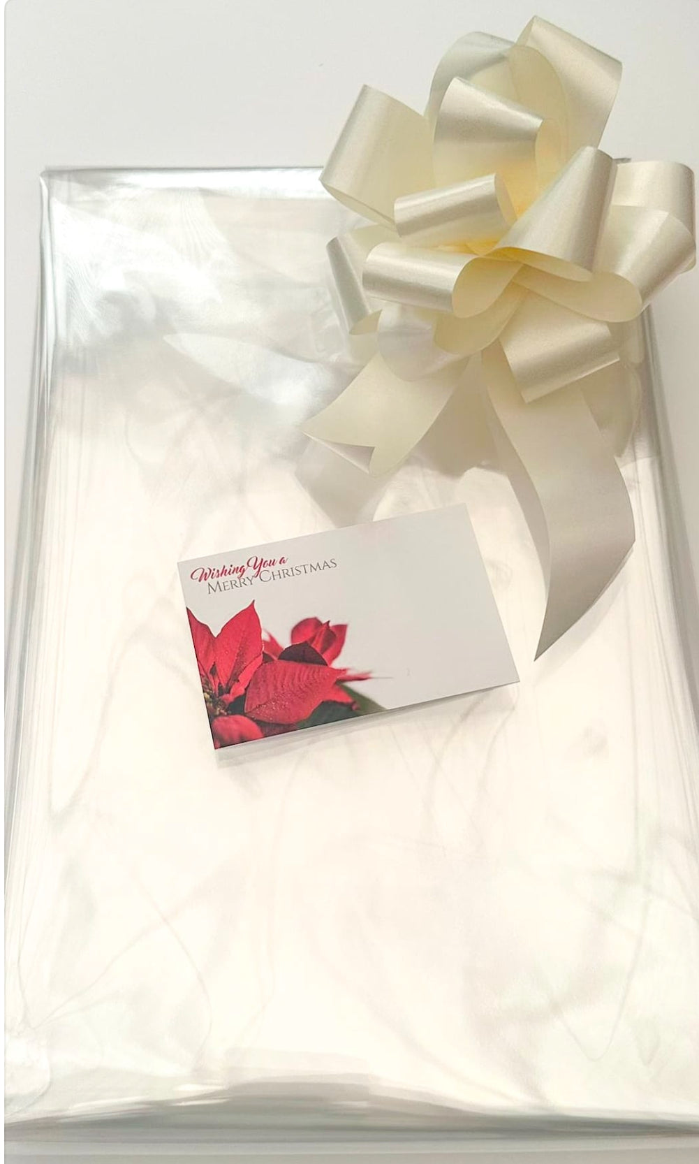 clear Cellophane hamper wrap / cream pull bow and Christmas message card